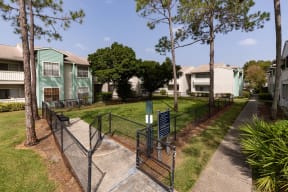 a fenced in yard in front of an apartment building
