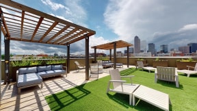 a rooftop lounge with a view of the minneapolis skyline