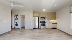 a kitchen with stainless steel appliances and a washer and dryer
