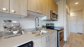 a kitchen with wooden cabinets and a stainless steel sink
