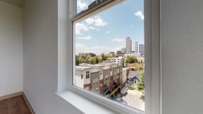 a large window in a room with a view of the city