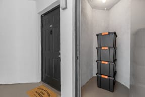 a room with a black door and a black shelf with orange tape on it
