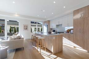 A modern kitchen with wooden cabinets and a large island in Hillcrest Ave located in Abbotsford, BC