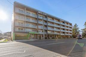 A large apartment building Hillcrest Ave, with a green awning located in Abbotsford, BC