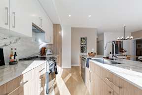 A modern kitchen with wooden cabinets and a marble countertop in Hillcrest Ave located in Abbotsford, BC