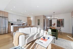 A modern living room with a white couch and a coffee table in Hillcrest Ave located in Abbotsford, BC