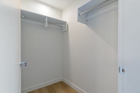 A white closet with a sliding door and a shelf above it in Hillcrest Ave located in Abbotsford, BC
