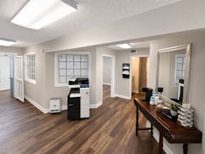 A clubhouse with coffee bar and printer  located at the pointe apartments in Pasadena, Tx