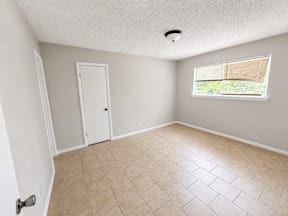 A room with large window and large walk in closet located at the pointe apartments in Pasadena, Tx