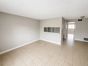 Spacious living room with window located at the pointe apartments in Pasadena, Tx