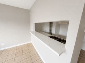 A kitchen area with a countertop and a sink located at the pointe apartments in Pasadena, Tx