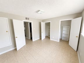 Spacious room with walk in closet and tiled flooring located at the pointe apartments in Pasadena, Tx