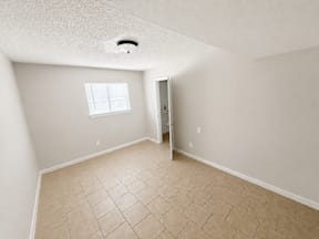 Spacious room with tiled flooring and large closet located at the pointe apartments in Pasadena, Tx