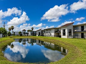 A pond in front of the apartment building located at the pointe apartments in Pasadena, Tx