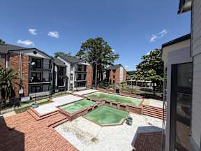 A backyard with a pool table and a basketball hoop located at Canfield Lakes Apartments in Houston TX
