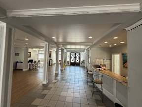 A long hallway with a kitchen area on the right located at Canfield Lakes Apartments in Houston TX