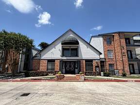 A modern house with a grey roof and a black door located at Canfield Lakes Apartments in Houston TX