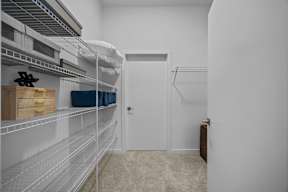 A white pantry with a door and shelves.at Address East End, Raleigh, 27610