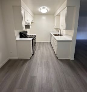 Kitchen with Hard Floors and White Cabinets