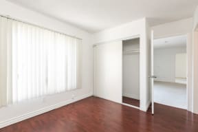 Bedroom with Hardwood Floors and Wardrobe Closet