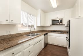Kitchen with Stainless Steel Appliances and White Cabinets