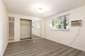 Bedroom with Hardwood Floors and Mirrored Wardrobe Closet