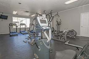 A gym with treadmills, exercise bikes, and other equipment at Laurel Parc apartments in Shreveport, LA.