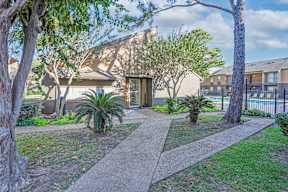 Walk paths surrounded by trees and plants at Stone Canyon apartments in Shreveport, LA.