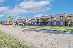 A row of apartment buildings with a clear blue sky above at Stone Canyon apartments in Shreveport, LA.