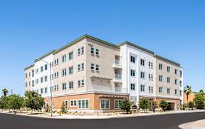 A large white building with a green roof and a number 1510 on it.