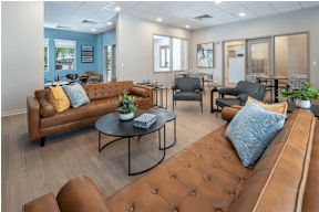 A living room with brown leather couches and a coffee table.