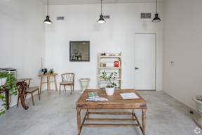 A room with a wooden table and chairs.