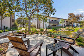 Outdoor seating overlooking a koi pond.