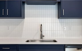 Kitchen sink with modern faucet and white subway tile backsplash at The Woods at Copper Ranch Apartments, Idaho, 83333