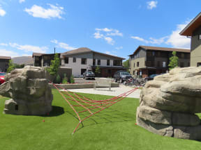 a hammock in the middle of a yard with rocks  at Lido Apartment Homes @ Hailey, ID, Hailey, ID 83333