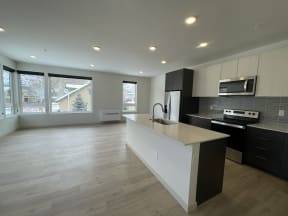 an empty kitchen with a large island and a large window at Lido Apartment Homes @ Hailey, ID, Hailey, ID 83333