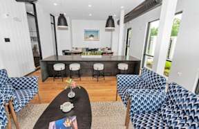 A modern living room with a black coffee table and blue patterned chairs. at DAWSON PARK Apartments , BATON ROUGE, LA, 70809