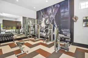 a workout room with a large picture of a man on the wall