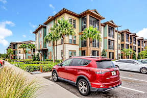 Red car parked at POINTE AT EAST SHORE APARTMENTS, APOPKA, 32703