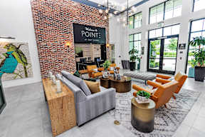 Clubhouse living room at POINTE AT EAST SHORE APARTMENTS, APOPKA, FL