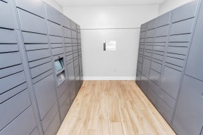 a room with gray lockers and a hardwood floor
