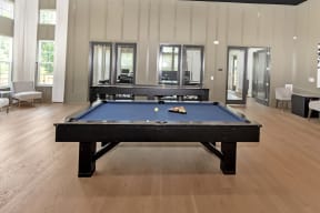 a large game room with a pool table and a ping pong table