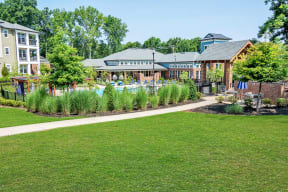 a grassy area with a path and a building in the background