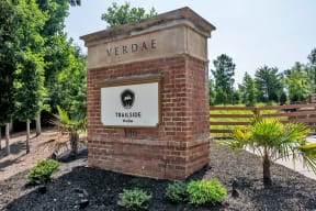 a brick monument with a sign that reads trailside