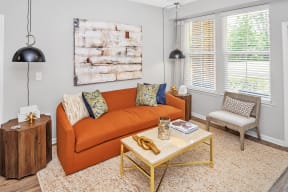 a living room with an orange couch and a coffee table