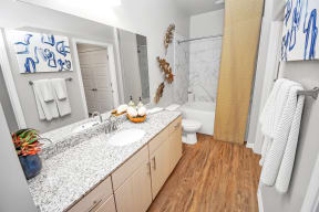 a bathroom with gray walls and a wooden floor