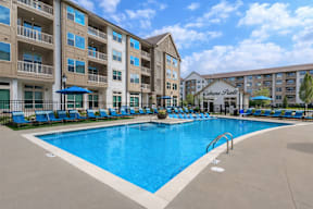 A large swimming pool in front of a hotel with a sign that says "Cabana Plaza".