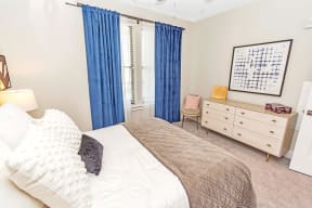 a bedroom with a bed and a dresser