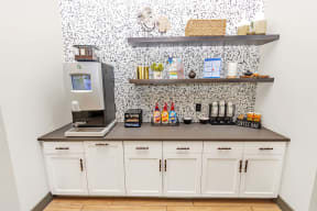 a coffee bar with a coffee machine and a coffeemaker on a counter