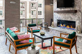 a living room with a fireplace and a balcony
